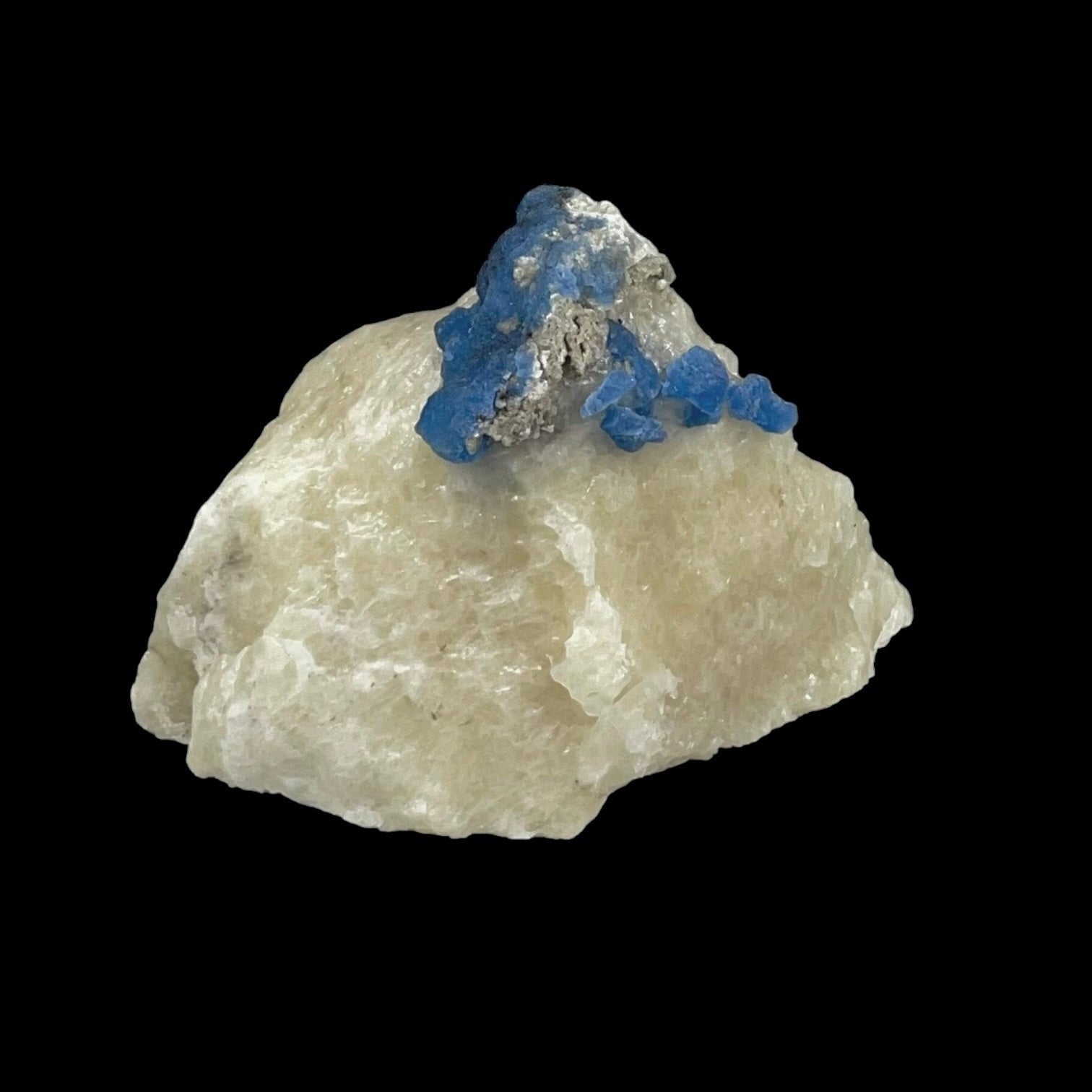 Fluorescent Afghanite blue crystals on a calcite matrix