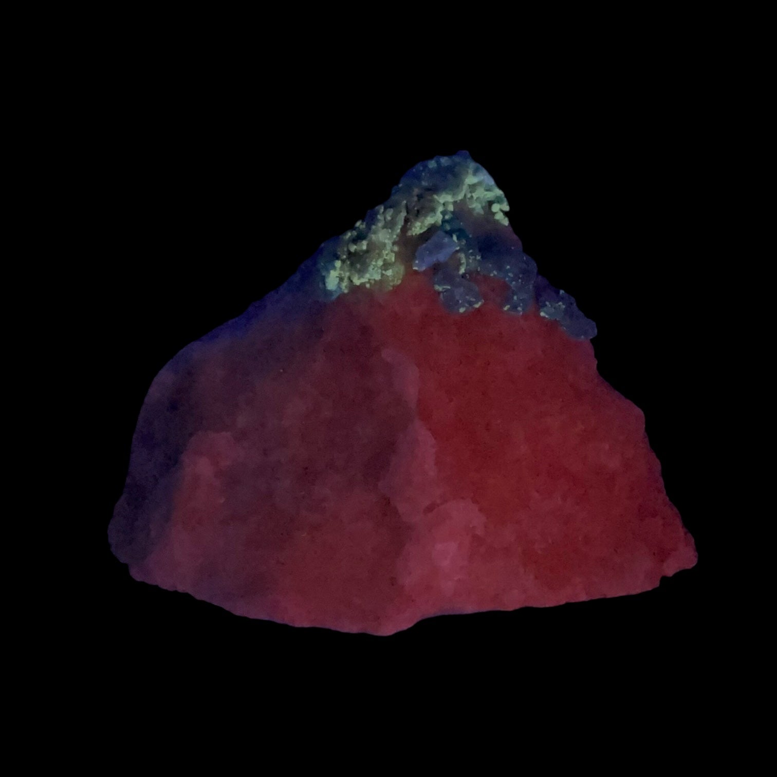 Fluorescent Afghanite blue crystals on a calcite matrix shown under 254nm short wave UV