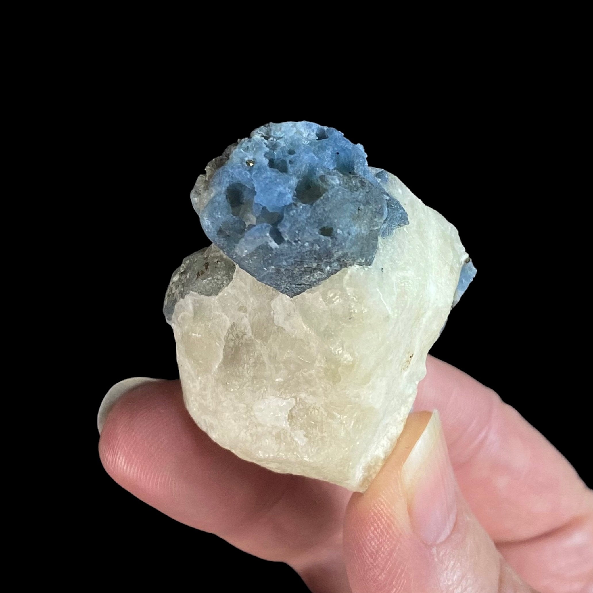 Fluorescent Afghanite blue crystals on a calcite matrix