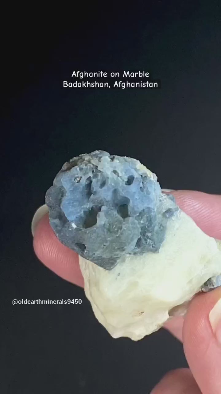 Fluorescent Afghanite blue crystals on a calcite matrix